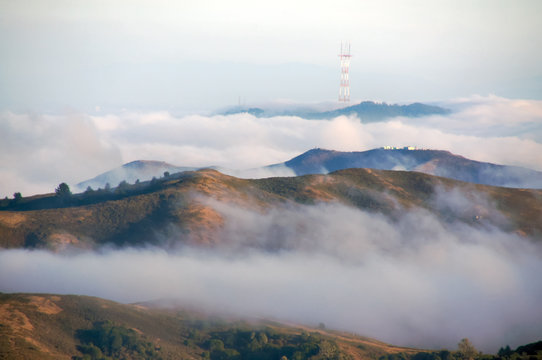 Fototapeta Twin Peaks and Mount Sutro with Sutro Tower in Fog. Shot taken frpm Mount Tam State Park, Marin County, California, USA.