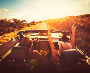 Couple Driving Convertable at Sunset