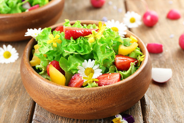 Light organic salad with flowers, close up