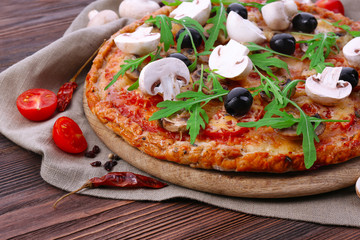 Tasty pizza with vegetables and arugula on table close up