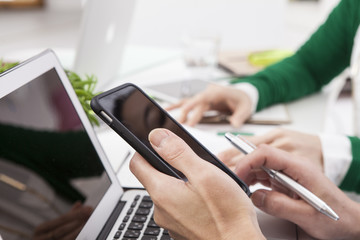 The hands of the businessmen are using the smartphone