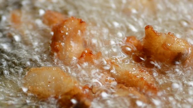 Close up hot bubble cooking oil of Thai style fried fish in pan