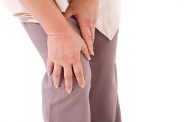 middle aged woman suffering from knee pain, joint injury or arth