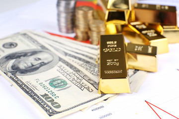 Gold bullion with money on table close up