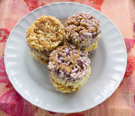 Thai dessert Khanom Nang Let, a round and flat sweetmeat made from fried dried rice and topping with sugar cane