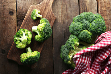 Fresh broccoli on wooden table close up
