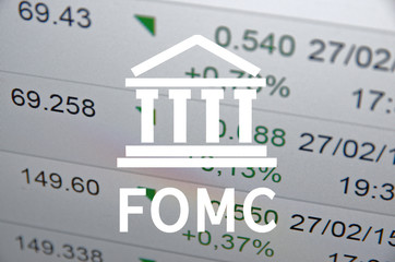 Building icon with inscription FOMC. Financial data on computer screen. Multiple exposure.