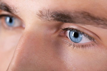 Fototapeta na wymiar Beautiful blue man eyes close up