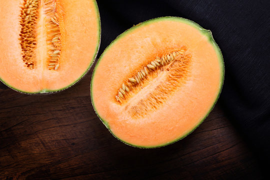 Organic cantaloupe on wooden table