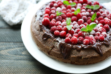Cake with Chocolate Glaze and raspberries on wooden background