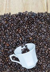 Cup of cofee with coffee beans on a wood table