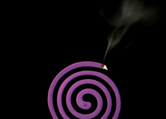 mosquito coil on black background