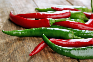 Hot peppers on wooden table close up