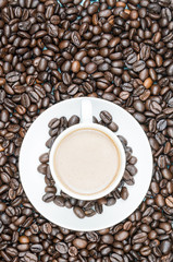 Cup of coffee on coffee bean background