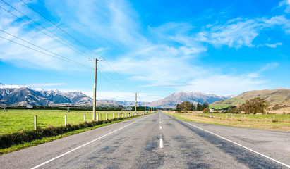 asphalt highway curve road to mountain cook New Zealand with clo