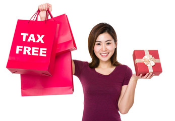 Woman hold with shopping bag and giftbox showing tax free