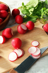 Fresh sliced radishes on cutting board close up