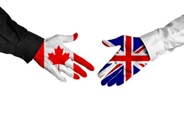 Canadian and British leaders shaking hands on a deal agreement