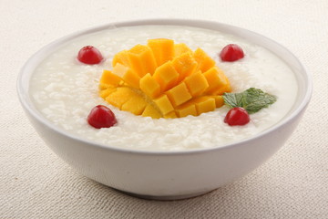 Healthy breakfast rice pudding with mango.