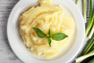Mashed potatoes in plate on wooden table, top view