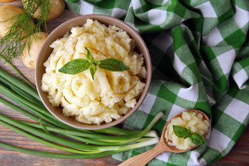Mashed potatoes in bowl on table with checkered napkin, closeup