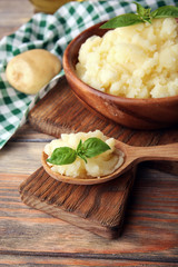 Mashed potatoes in bowl on wooden table, closeup