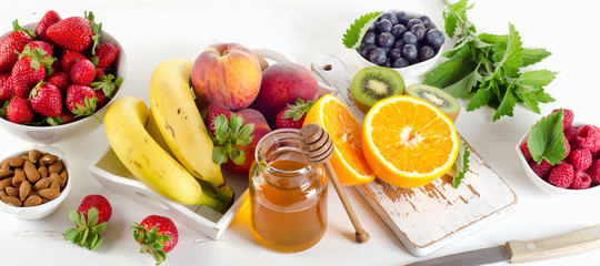 Fresh mixed fruits, honey and berries.