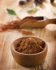 Cacao powder in a wooden bowl.