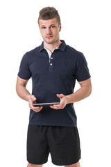 Handsome young personal trainer with tablet PC © theartofphoto