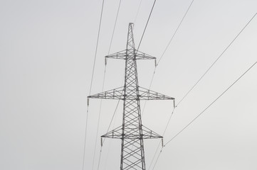 Electric high voltage power post, abstract view in morning haze