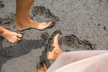 Couple's feet in the mud