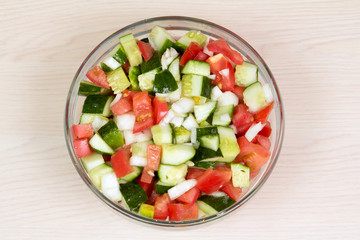 Vegetable salad with onion, tomato and cucumber