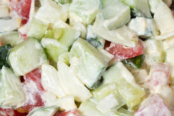 Vegetable salad with onion, tomato and cucumber as a background