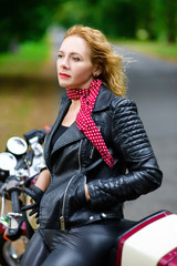 Plakat Biker girl in leather jacket on a motorcycle
