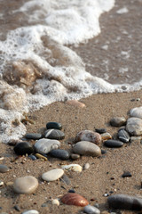 seacoast with fine sand and small round stones