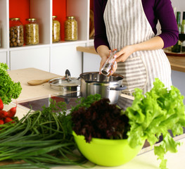 A young girl in kitchen while cooking