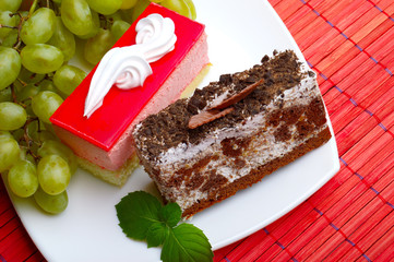 cakes, a bunch of grapes and mint leaves