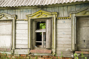 The windows in the wall of the old wooden house