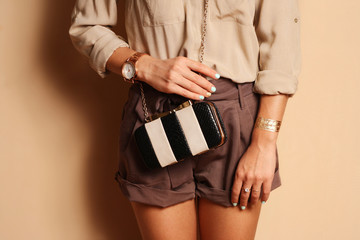 Fashionable woman with  stylish black and white clutch