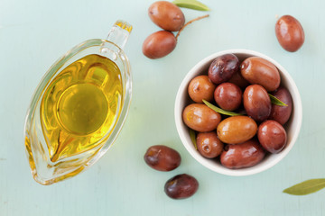 Fresh olives in white bowl on rustic wooden table