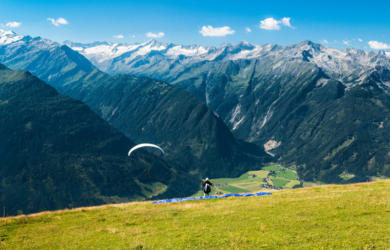 paraglider ready for start in austrian summer alps with epic view