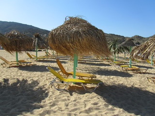 straw umbrellas on the empty beach