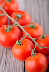 Tomatos on old wood background. Healthy and tasty food