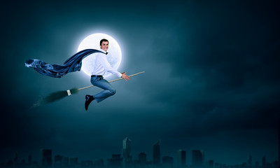Businessman on broom