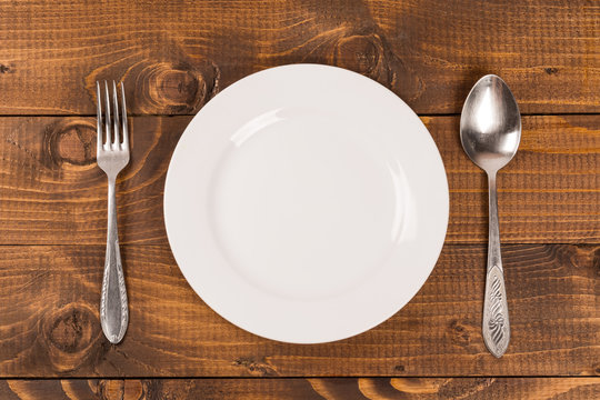 spoon and fork on a plate on the table