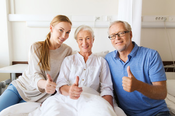 happy family visiting senior woman at hospital