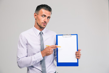 Businessman showing blank clipboard