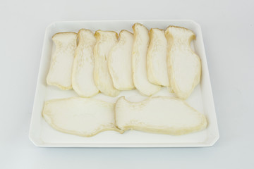 Eringii mushroom on white plate, isolated.