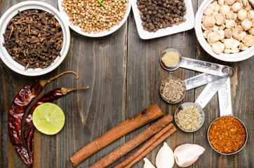 Herbs and spices on wooden background