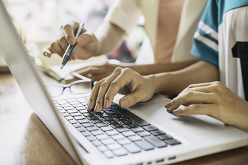 women working on a project in a cafe 